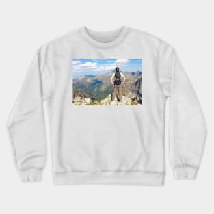 Woman with backpack standing on the edge, looking at mountains Crewneck Sweatshirt